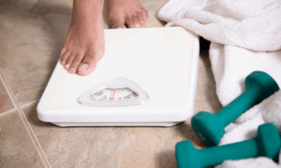 Child measuring height and weight for growth tracking